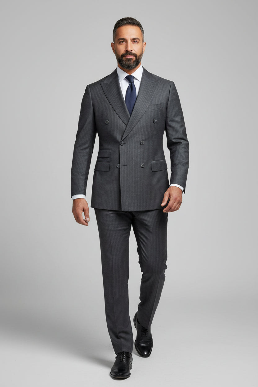 Man in charcoal pinstripe double-breasted suit with tailored fit and tie.