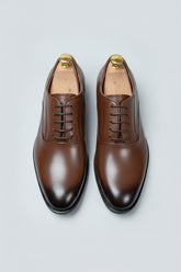 Brown leather classic derby shoes with lace-up design for formal occasions.
