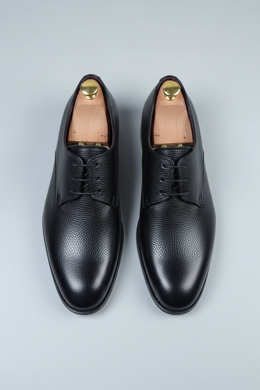 Black leather lace-up dress shoes with a classic design and smooth finish.