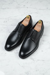 Black leather lace-up dress shoes with polished finish for formal occasions.
