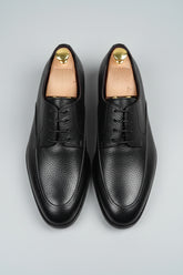Black leather lace-up dress shoes with textured finish, ideal for formal wear.