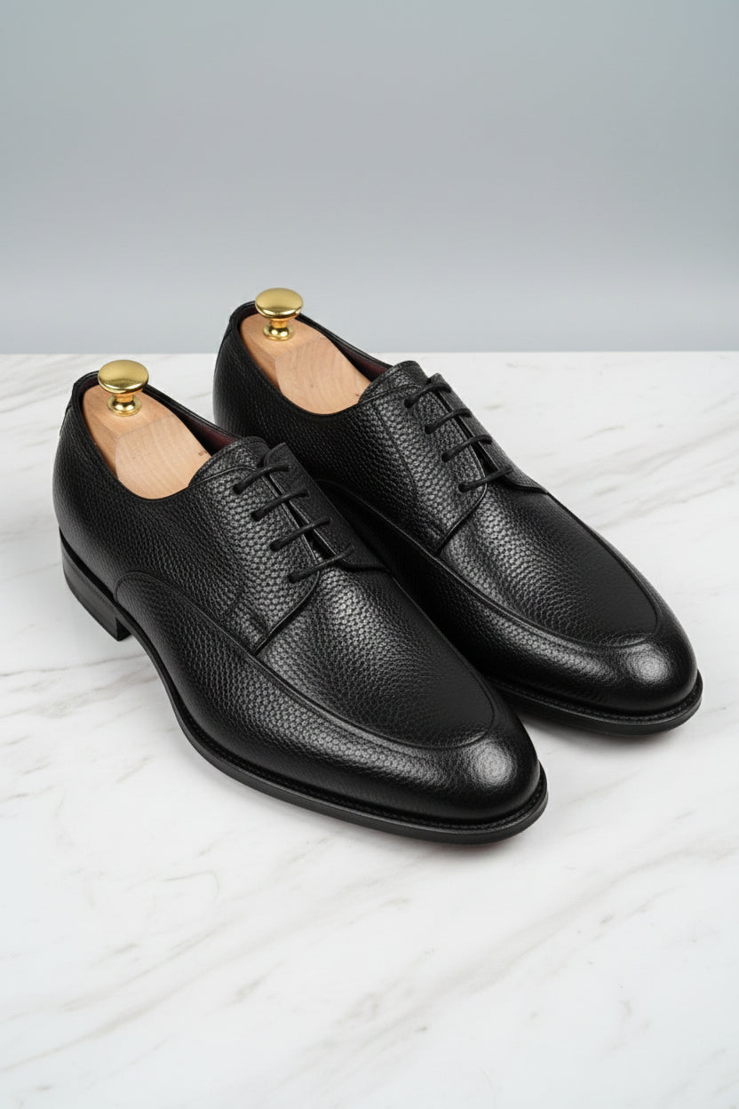 Black leather lace-up dress shoes with classic style and textured finish.