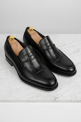 Black textured leather formal loafers with elegant design for business or weddings.