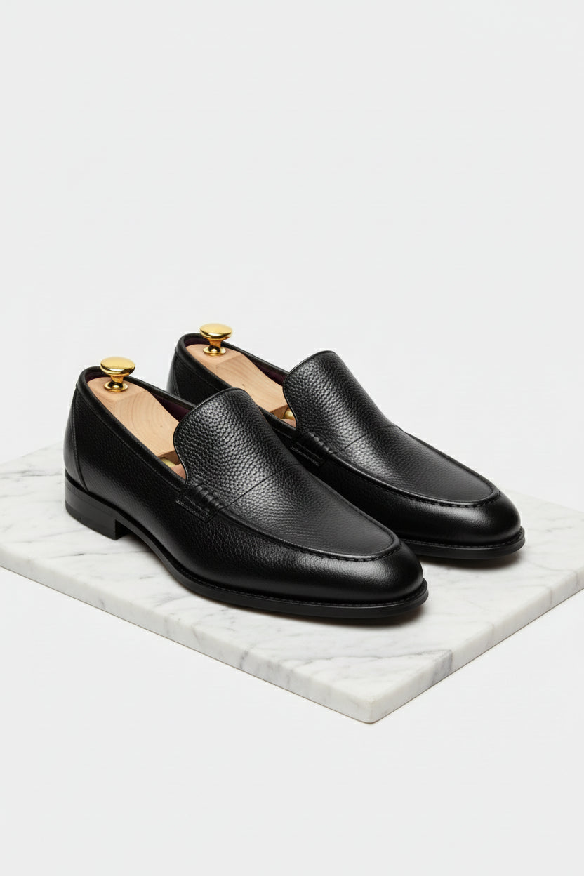 Black slip-on leather tuxedo shoes with elegant design, ideal for formal events.