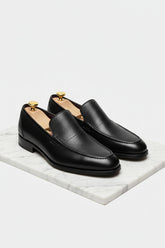Black slip-on leather tuxedo shoes with elegant design, ideal for formal events.