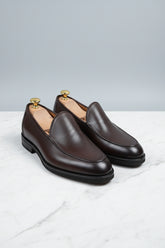 Brown slip-on leather formal shoes with elegant design and textured finish.