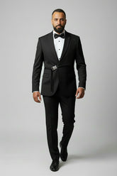 Man in black slim fit suit with sequin detail and bow tie for formal events.