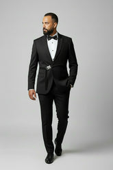 Man wearing black slim fit suit with sequin detail and bow tie.