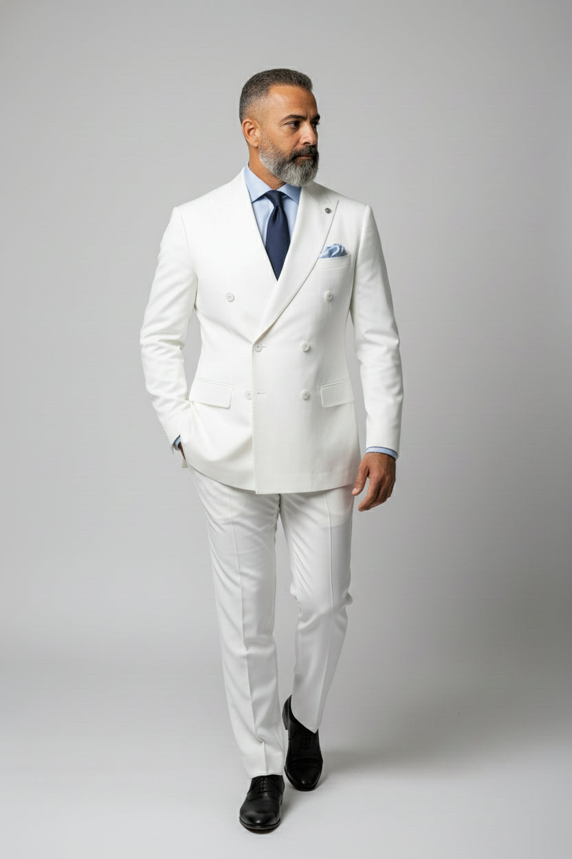 Man in white double-breasted dinner suit with peak lapels and tailored fit.
