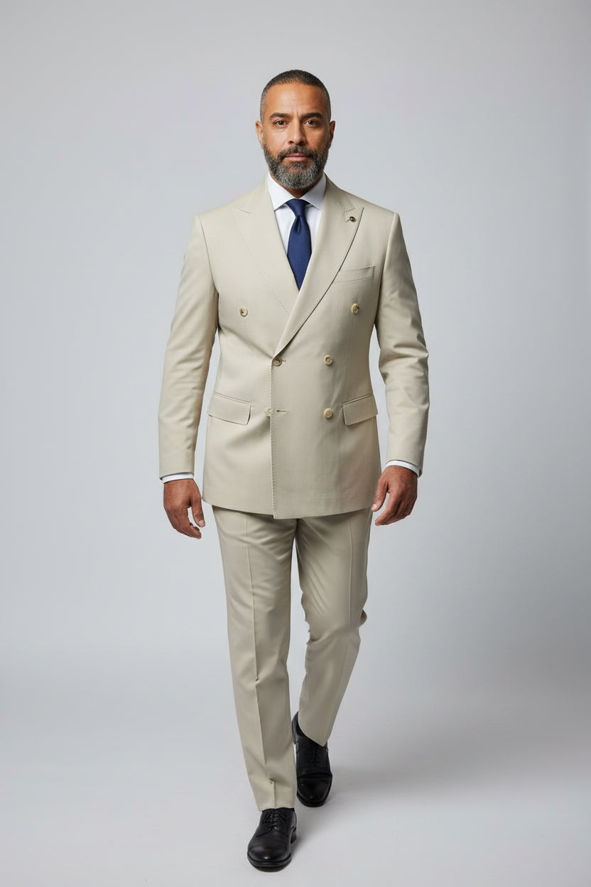 Man wearing beige double-breasted suit with peak lapels, ideal for formal events.