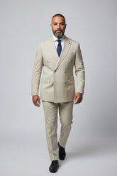 Man wearing beige double-breasted suit with peak lapels, ideal for formal events.