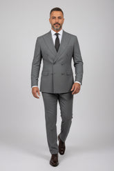 Man wearing gray double-breasted suit with tailored fit and matching trousers.
