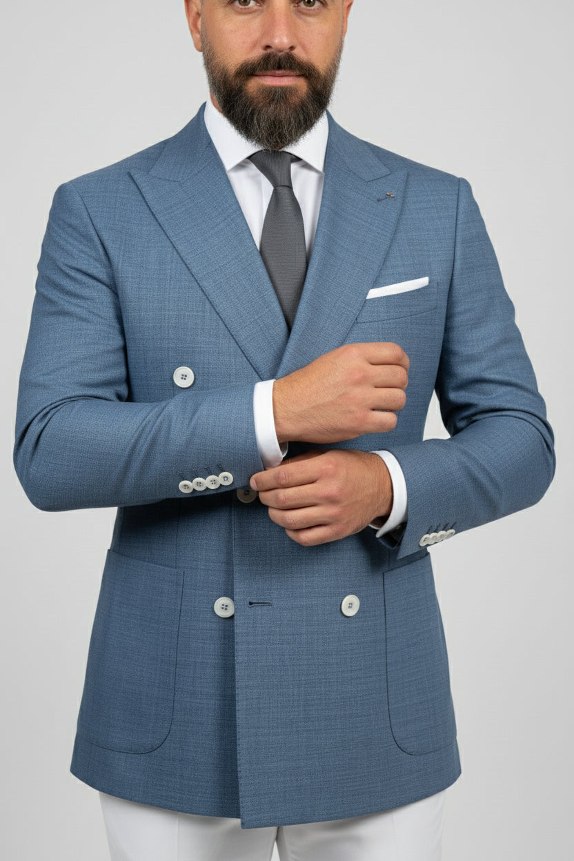 Man wearing midnight petrol double-breasted suit with tailored fit and white accents.
