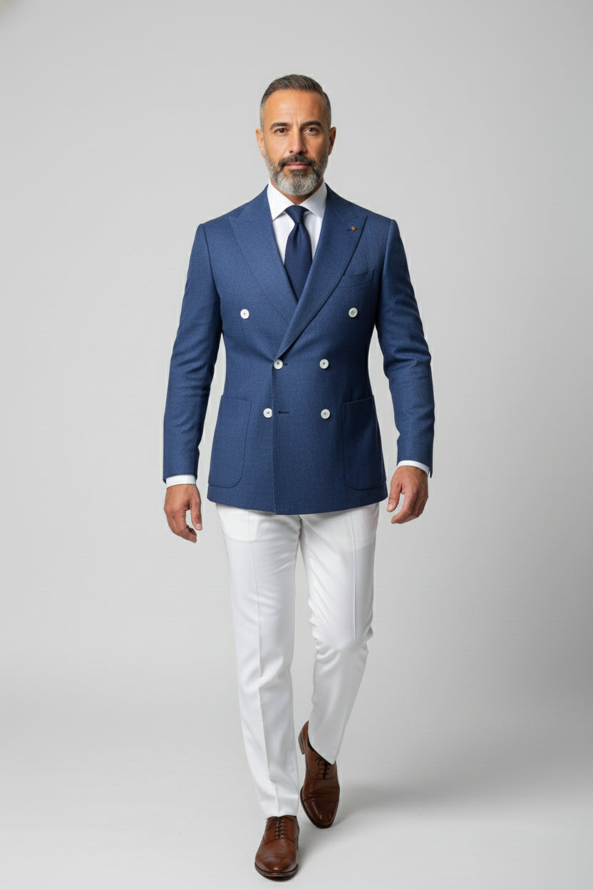 Man in blue double-breasted suit with white trousers, perfect for upscale events.