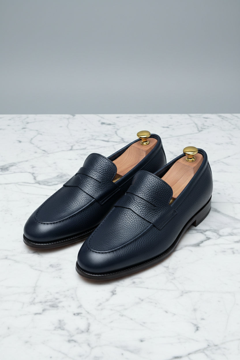Midnight blue leather loafers with textured finish, perfect for business casual wear.