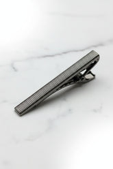 Silver textured tie clip with a classic design for formal business attire.