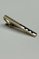 Gold textured tie clip with a sophisticated design for formal occasions.