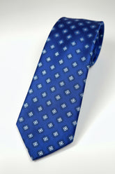 Blue silk patterned tie featuring geometric designs, perfect for formal occasions.