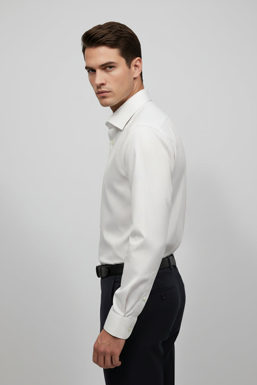 Man wearing white striped slim fit dress shirt with tailored fit and elegant design.