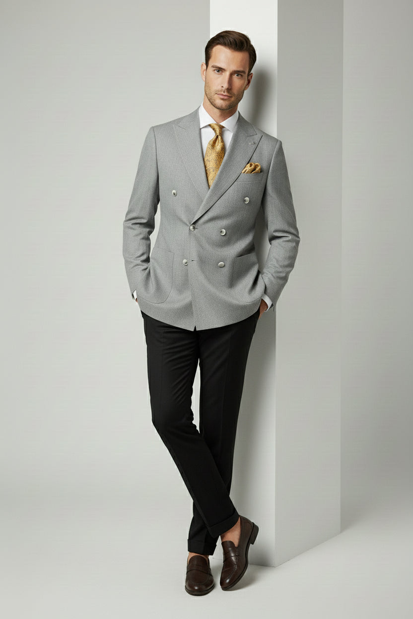 Man in grey double-breasted combination suit with black trousers and gold tie.