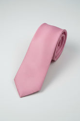 Textured pink silk tie rolled for formal wear at weddings or business events.