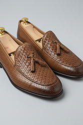 Brown woven leather loafers with tassels, perfect for casual and formal wear.