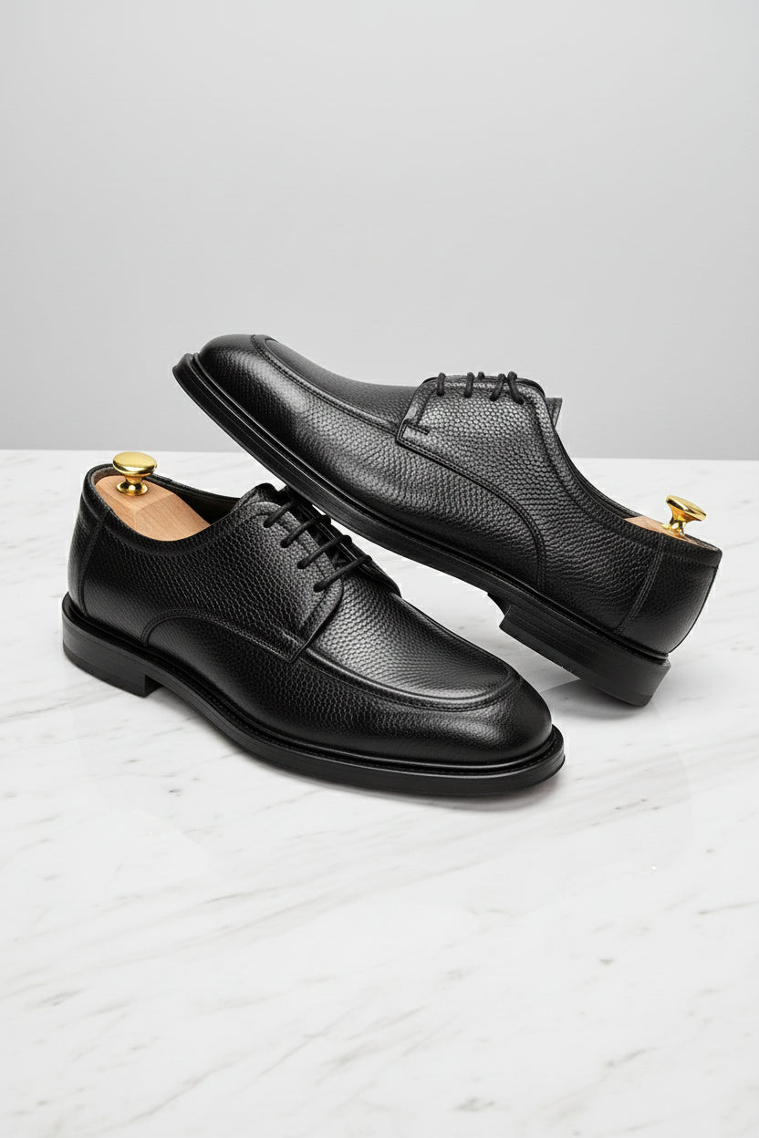 Black leather Oxford shoes with classic design and durable finish, perfect for formal occasions.