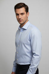 Man wearing light blue striped slim fit shirt with tailored fit for business attire.