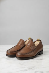 Chestnut brown leather penny loafers on display - Suit Sartoria UAE