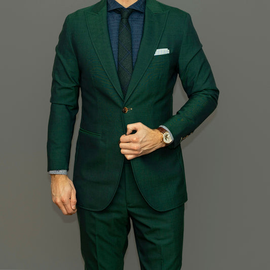 man in blue suit jacket and black pants