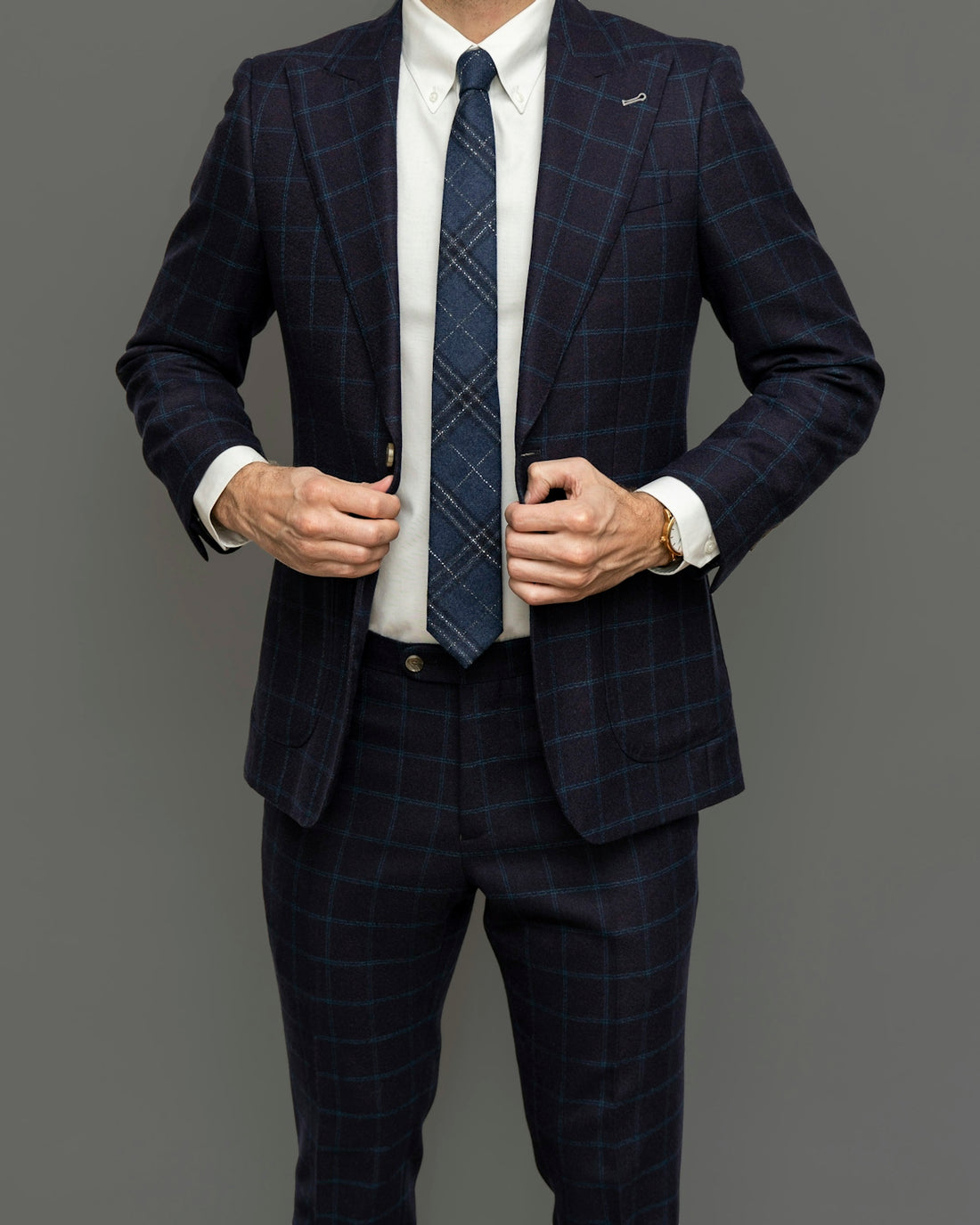 man in black suit jacket and black and white striped necktie