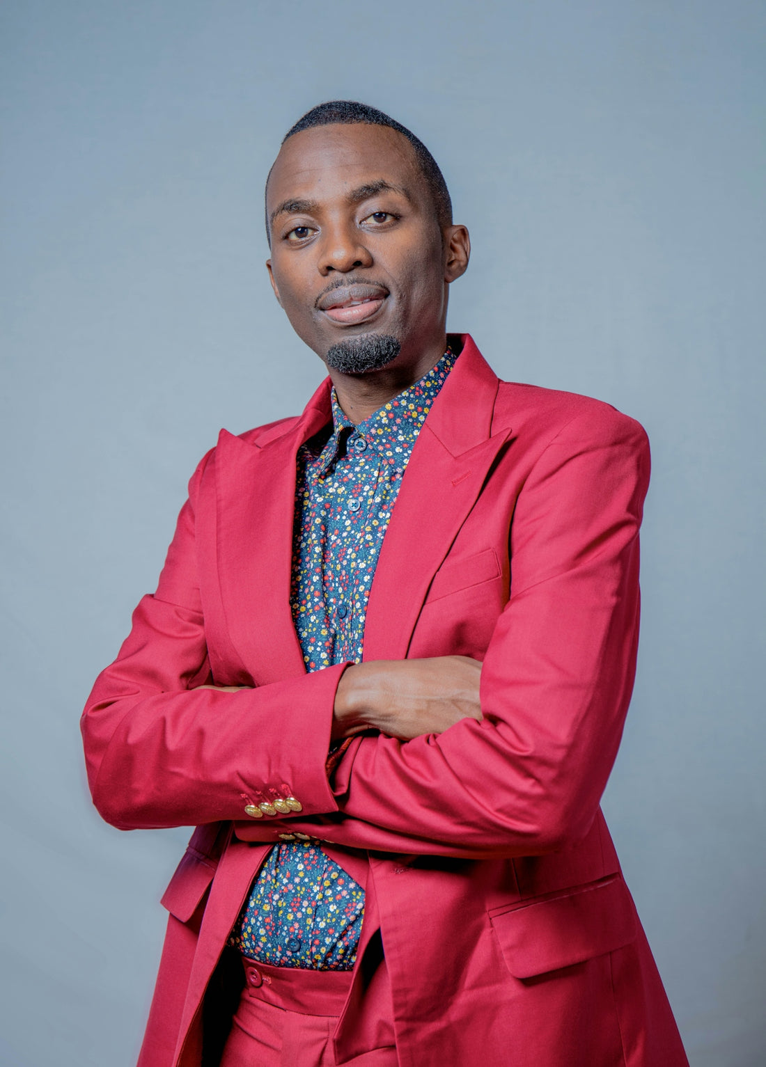 a man in a red suit posing for a picture