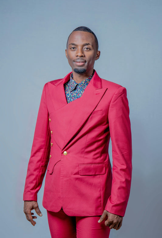 a man in a pink suit posing for a picture