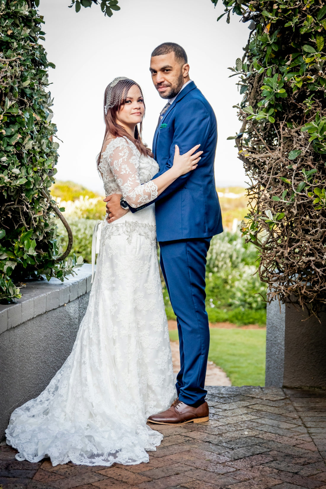 a bride and groom pose for a wedding photo