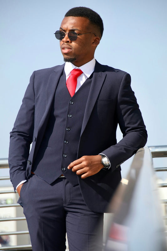 a man in a suit and red tie