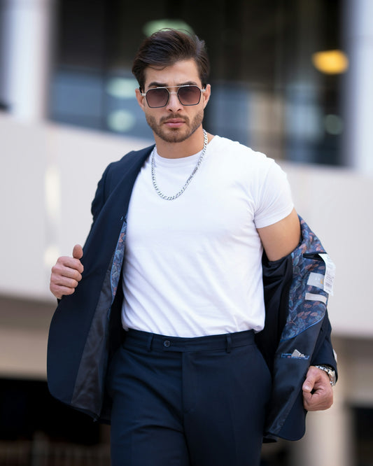 a man wearing sunglasses and a white t - shirt