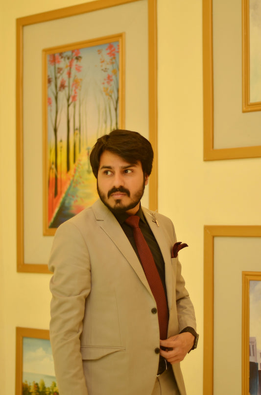 a man in a suit and tie standing in front of paintings