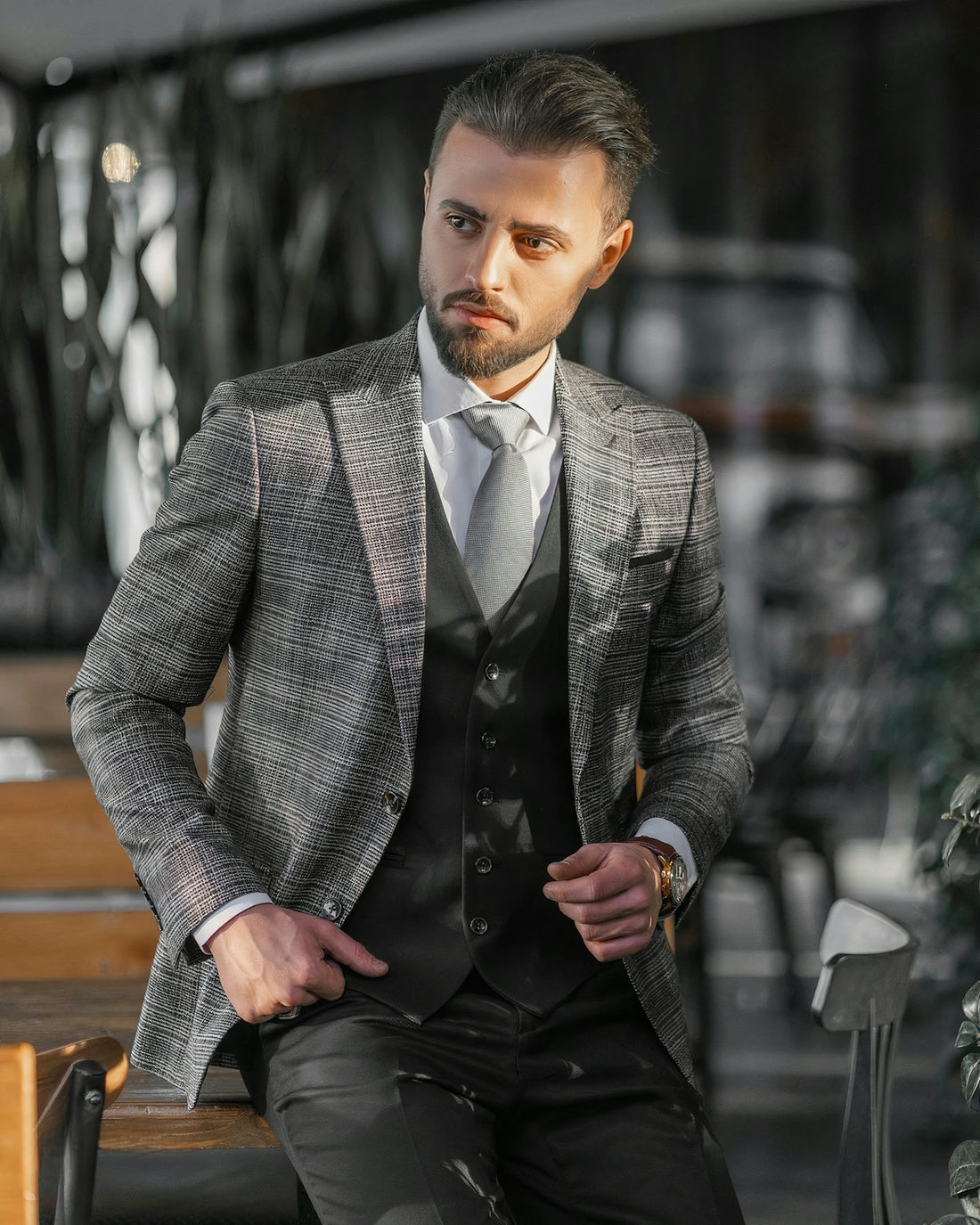 a man in a suit sitting on a bench