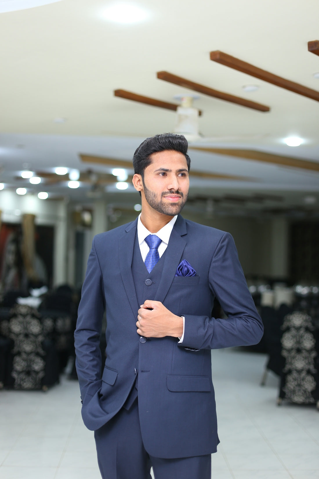 a man in a suit standing in a room