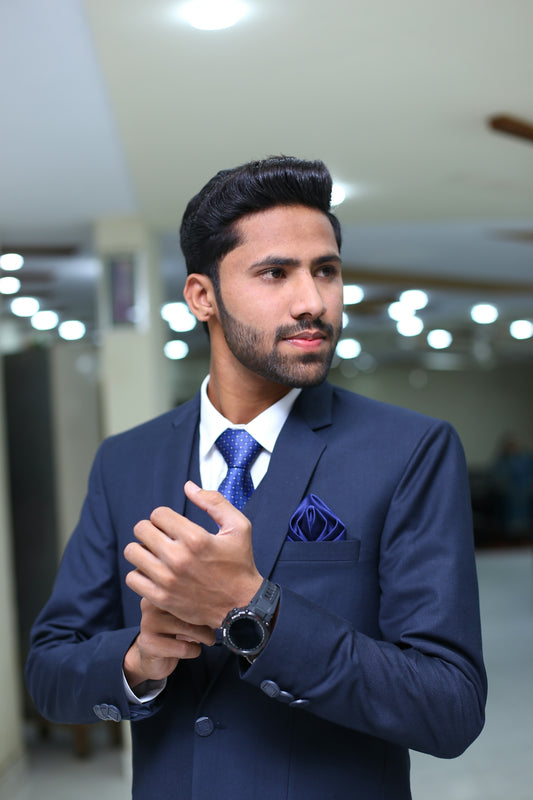 a man in a blue suit and blue tie