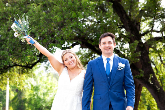 A smiling bride and groom in formal wedding attire
