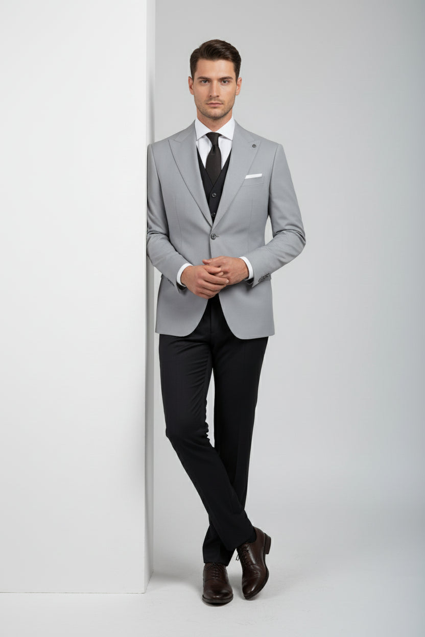 Man wearing light grey double-breasted suit with tailored fit and black trousers.