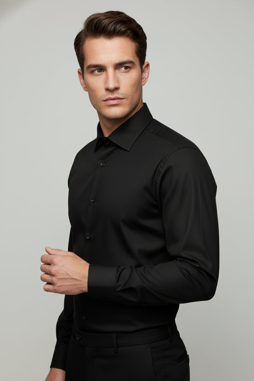 Man wearing black regular fit dress shirt with classic collar, ideal for formal events.