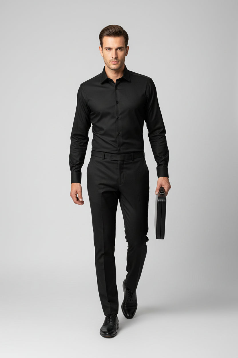 Man wearing black regular fit dress shirt with classic collar and formal trousers.