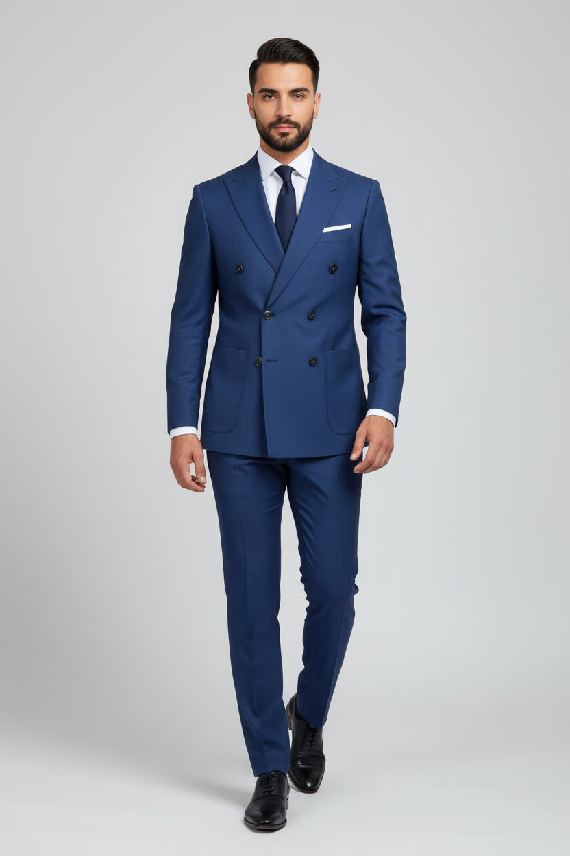 Man wearing navy double-breasted suit with unique detailing and tailored fit.