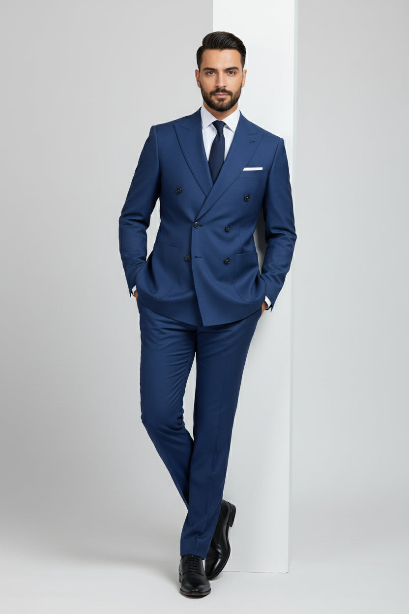 Man in tailored navy double-breasted suit with unique detailing and tie.
