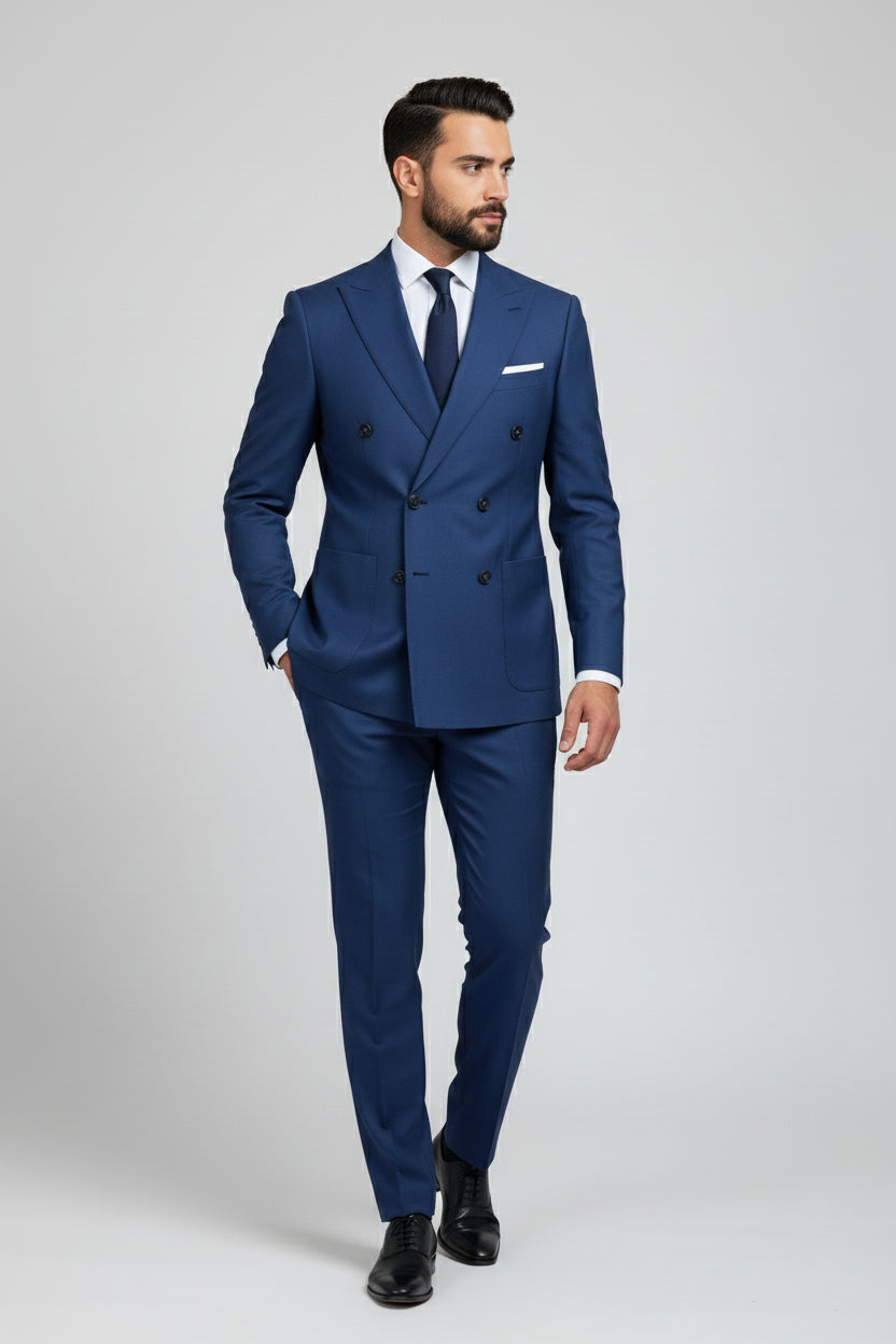 Man in tailored navy double-breasted suit with unique detailing and tie.