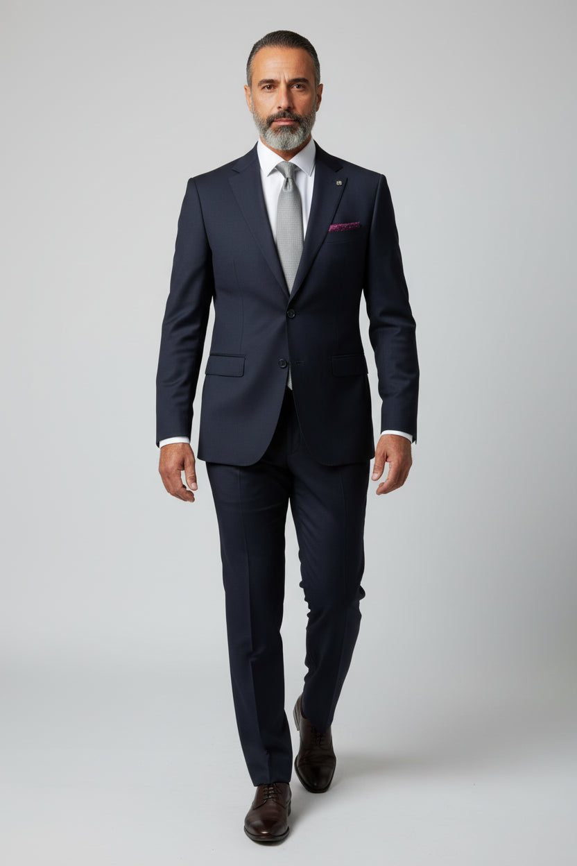 Man wearing navy slim fit suit with paisley lining, ideal for weddings and business events.
