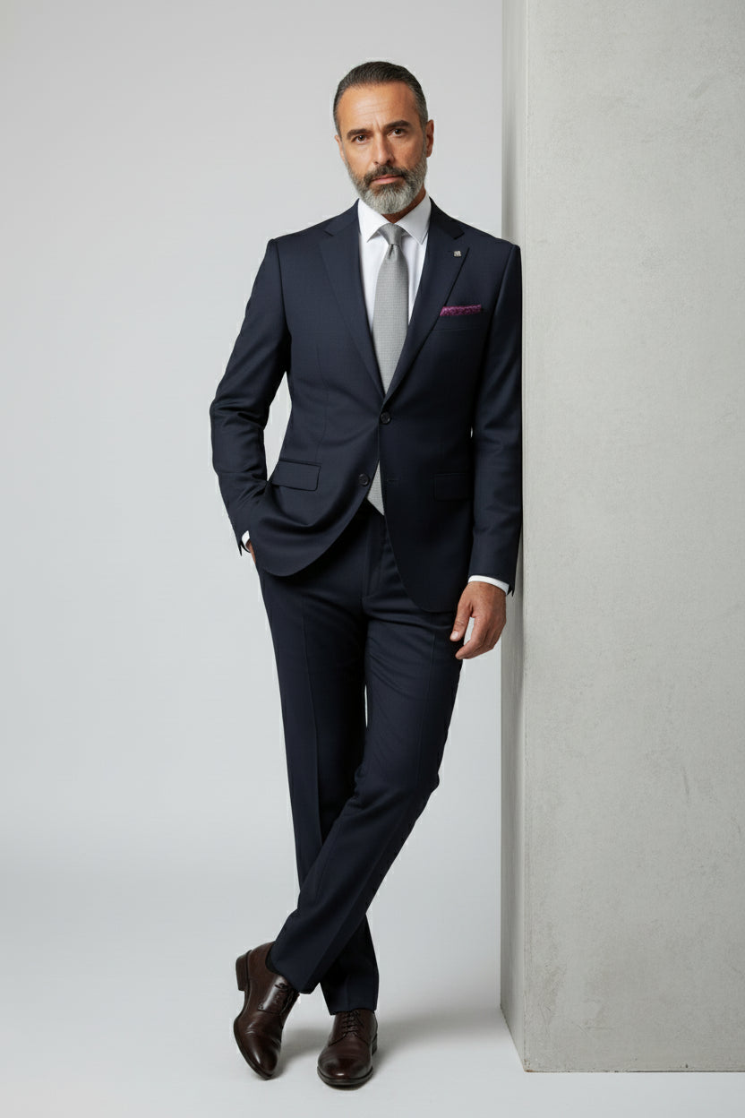 Man wearing navy slim fit suit with paisley lining, perfect for weddings or business events.
