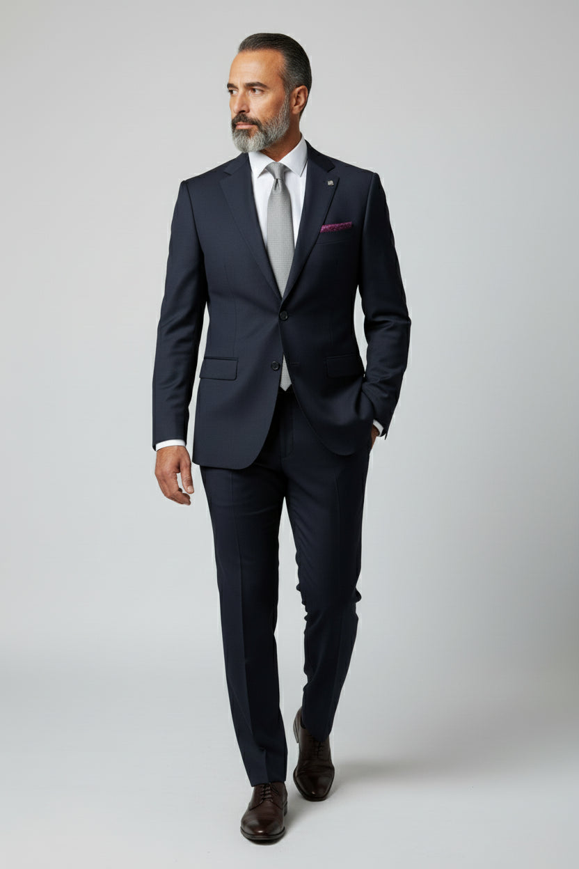 Man wearing navy slim fit suit with paisley lining, perfect for weddings or business events.
